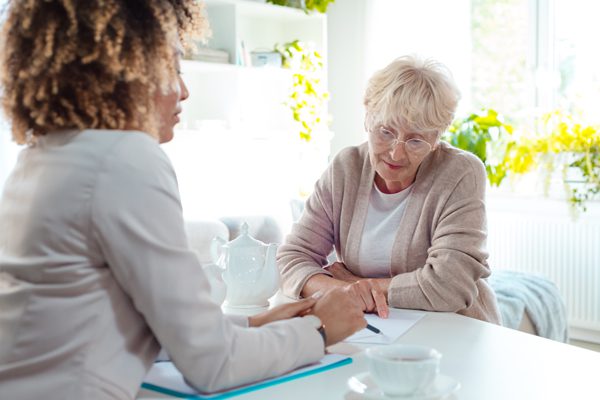 A woman sitting at a table with another person.