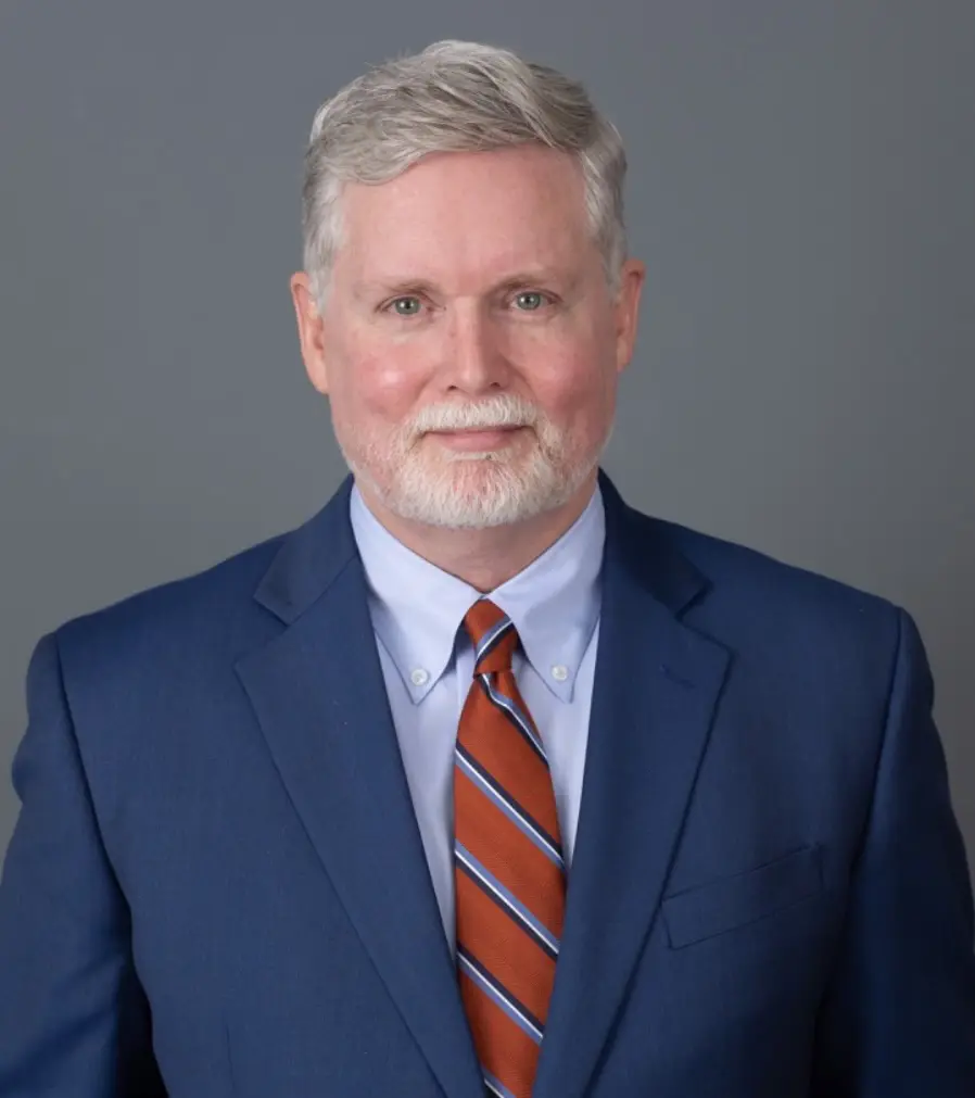 A man in a suit and tie standing up.